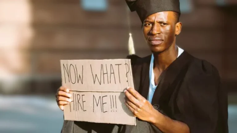 Graduate holding a placard highlighting Nigeria’s graduate unemployment crisis and the struggle for opportunities after earning a degree.