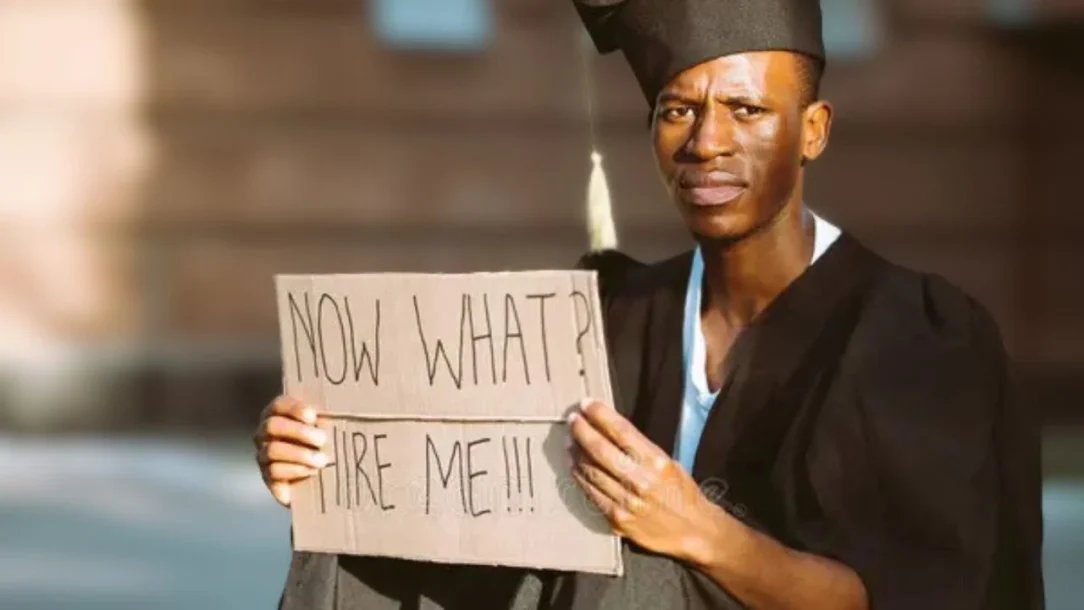 Graduate holding a placard highlighting Nigeria’s graduate unemployment crisis and the struggle for opportunities after earning a degree.